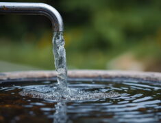 East Palestine Ohio water crisis 2026 showing contaminated tap water with chemical odor warning signs and residents collecting bottled water on April 9 2026