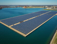 Aerial view of the United States’ largest floating solar farm on Lake Erie in northern Ohio, showing 200 acres of sun-tracking solar panels on the water surface generating clean energy for 15,000 homes while reducing harmful algae blooms