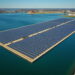 Aerial view of the United States’ largest floating solar farm on Lake Erie in northern Ohio, showing 200 acres of sun-tracking solar panels on the water surface generating clean energy for 15,000 homes while reducing harmful algae blooms